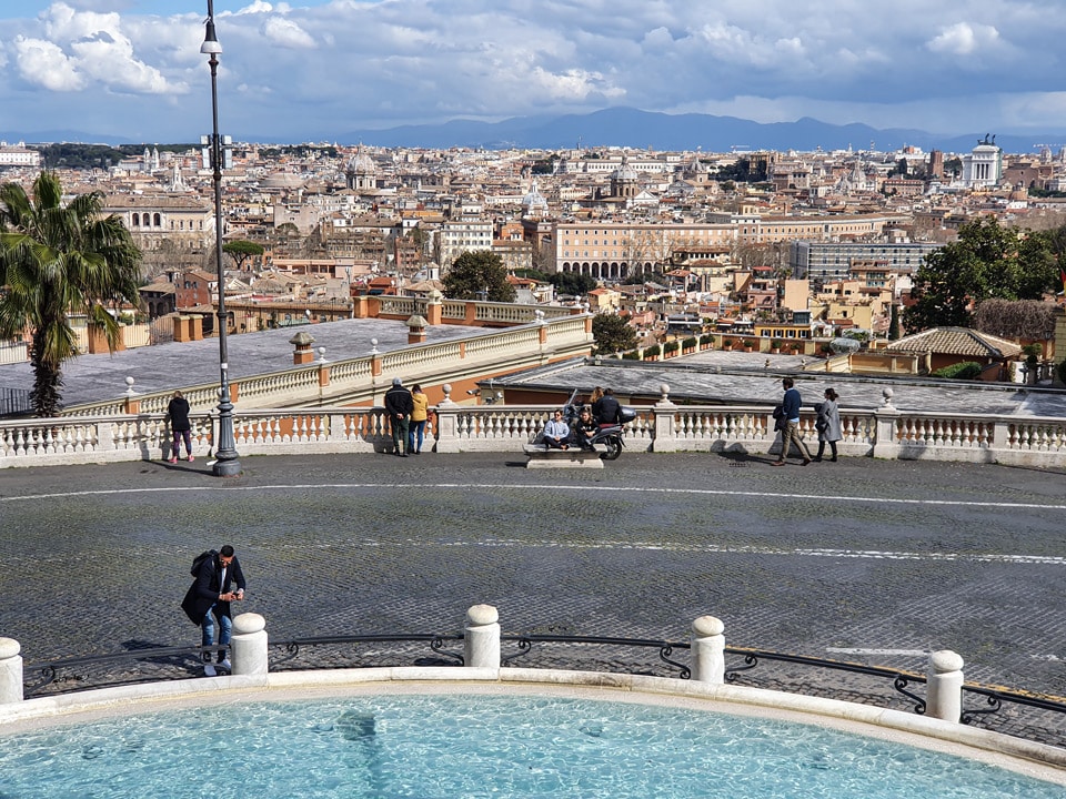 Panorama of Rome from the Acqua Paola fountain terrace on the Janiculum Hill, with the dome of the Pantheon and the twin towers of Trinità dei Monti visible on the skyline
