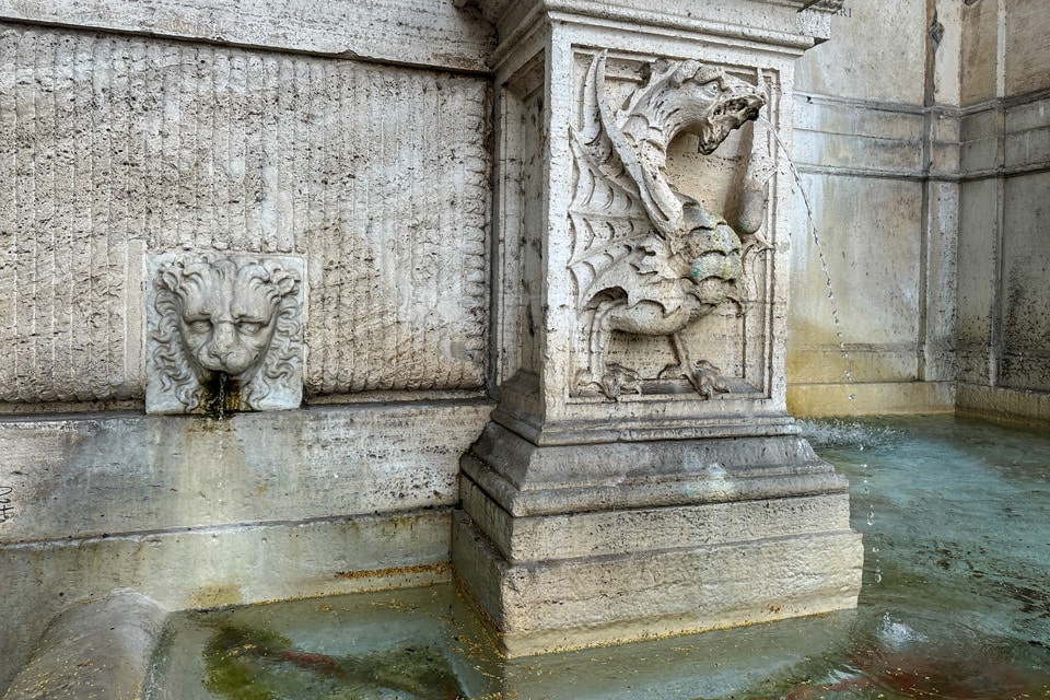 Borghese heraldic dragon spouting water and a lion mask on the Fontanone di Ponte Sisto, Piazza Trilussa, Rome