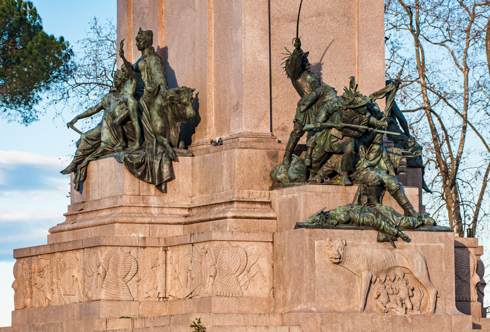 Bronze allegorical sculpture groups and Capitoline she-wolf relief on the pedestal of the Giuseppe Garibaldi monument, Rome