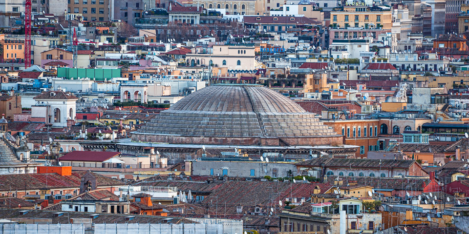 Upper rings of the Pantheon dome among Rome's rooftops as seen from Piazzale Garibaldi