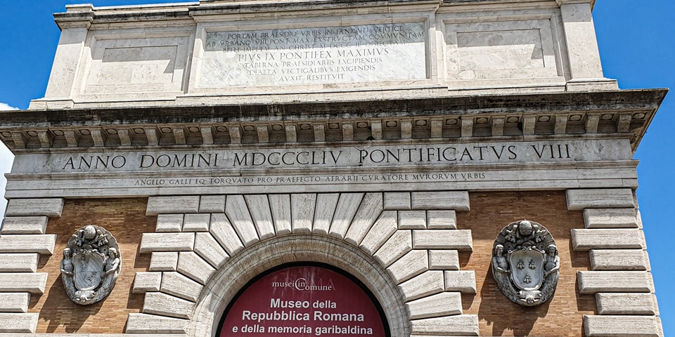 Latin reconstruction inscriptions and coats of arms of Popes Pius IX and Urban VIII above Porta San Pancrazio in Rome