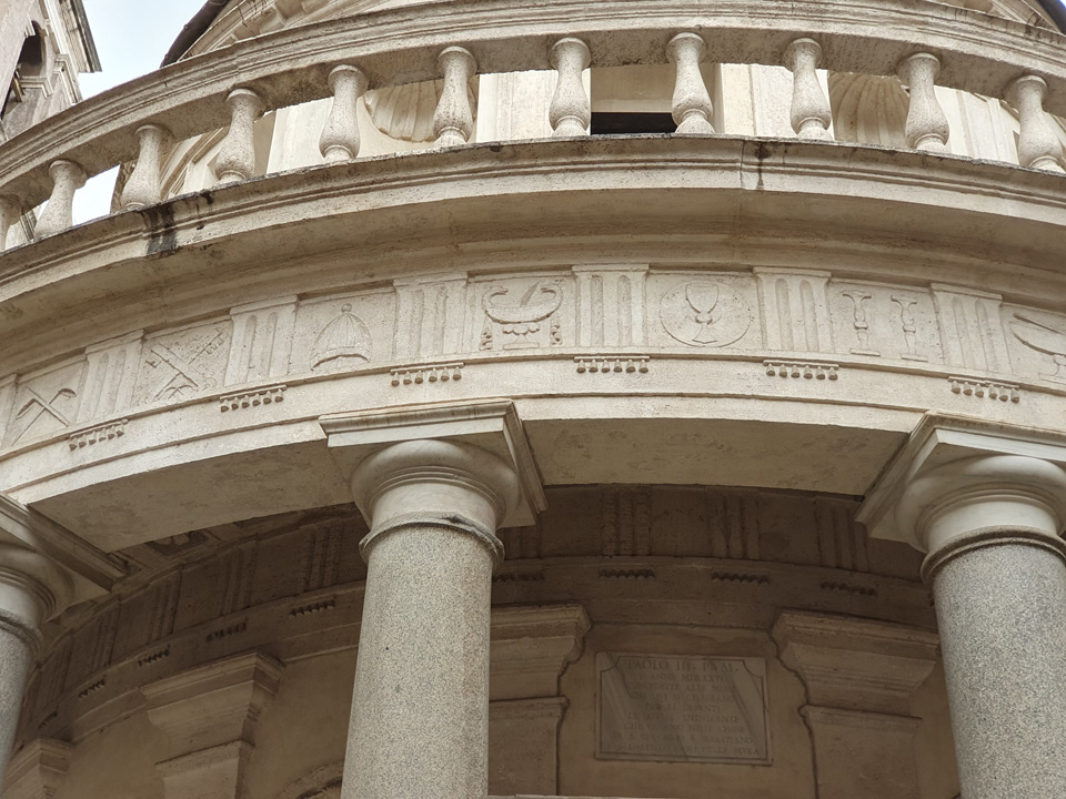 Doric frieze of the Tempietto with triglyphs and metopes carved with papal and liturgical symbols